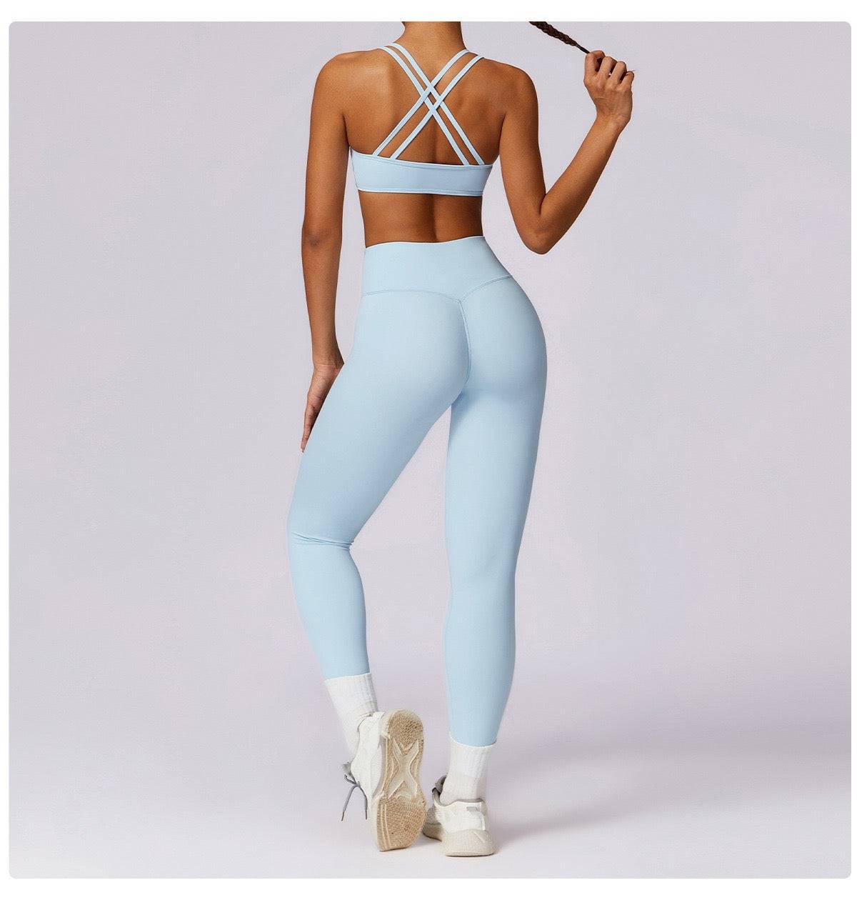 Woman wearing light blue high-waist gym leggings and sports bra from the back