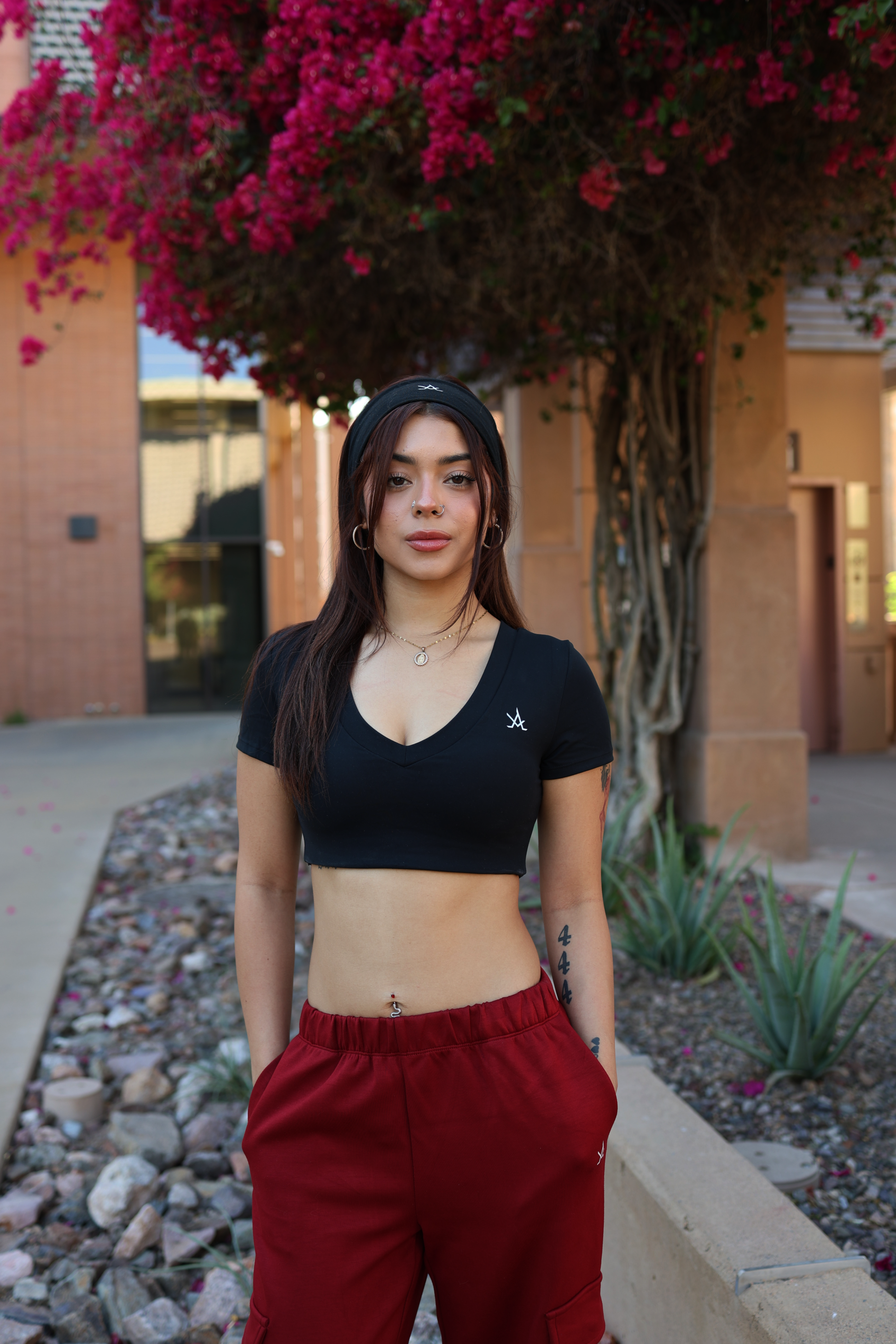 Woman wearing premium active sweat pants joggers in red with black crop top outdoors