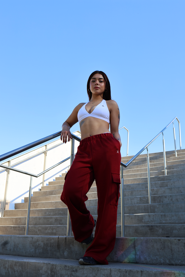 Athletic woman wearing ultimate comfort athletic sports bra and red pants on outdoor stairs