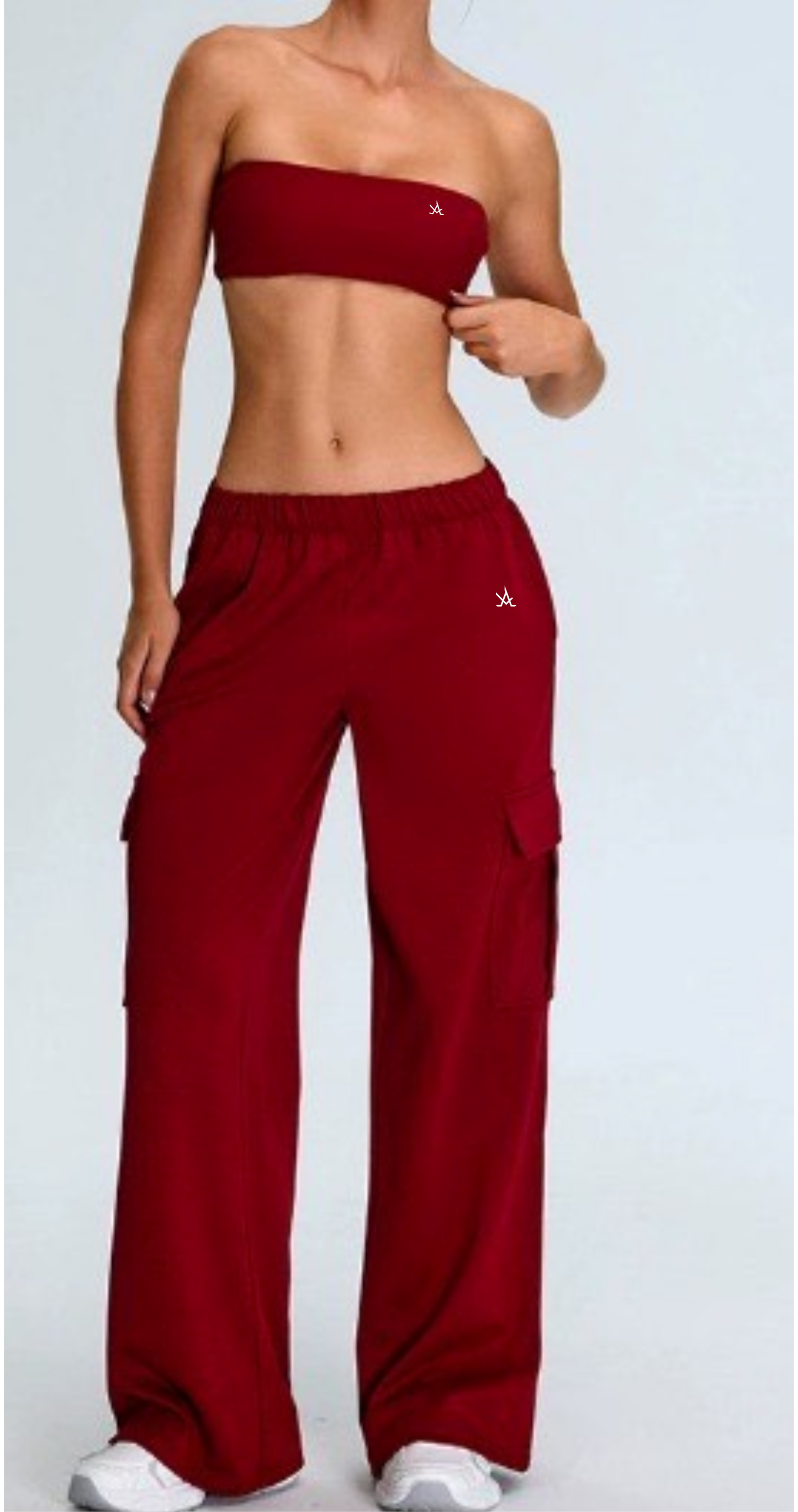 Woman wearing premium active sweat pants in burgundy with loose fit and cargo pockets, styled with a matching tube top and white sneakers.