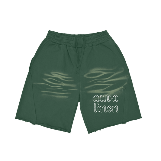 Dark green relaxed fit Aura shorts with elastic waistband and "aura linen" text design, made from thick 100% cotton fabric.