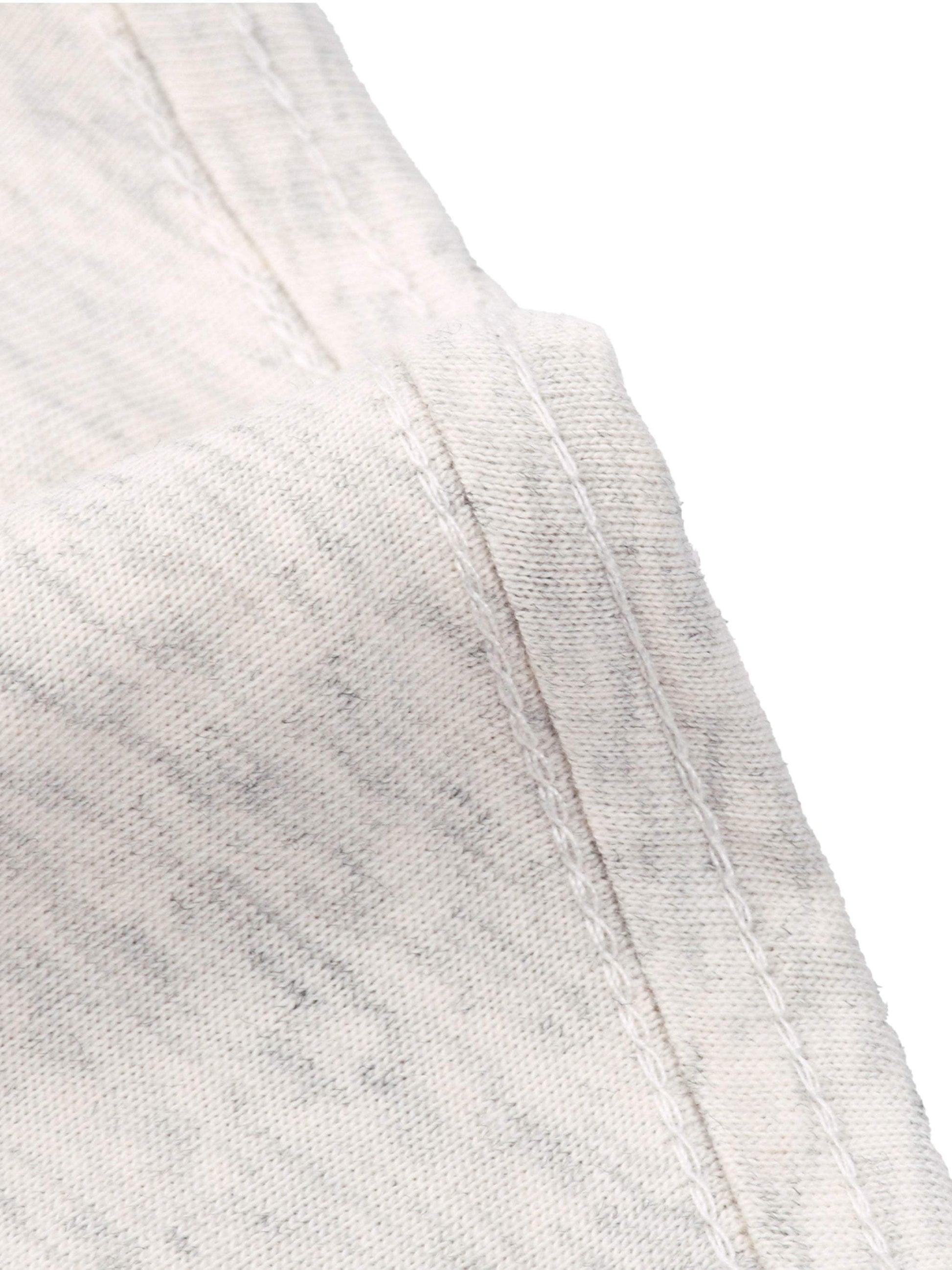 Close-up of white cotton Essential T-Shirt fabric and stitching detail